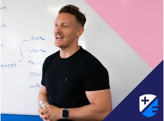 Teacher Gavin Cowzer speaking in front of a whiteboard