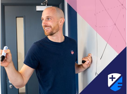 Teacher Barry Drumm in front of a whiteboard