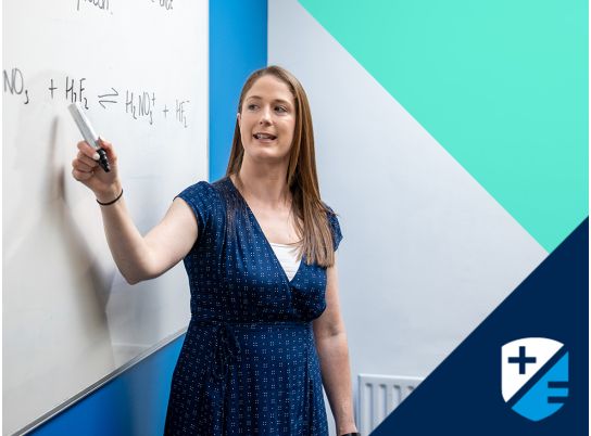 Teacher Claire O'Brien speaking in front of a whiteboard