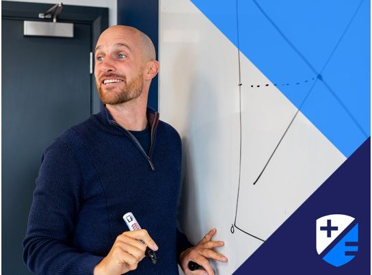 Teacher Barry Drumm in front of whiteboard