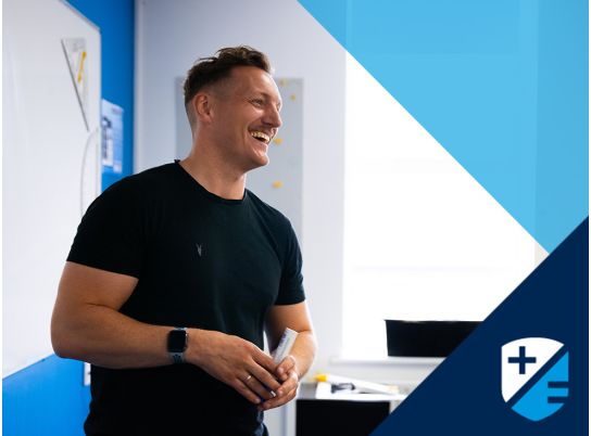 Teacher Gavin Cowzer speaking in front of whiteboard