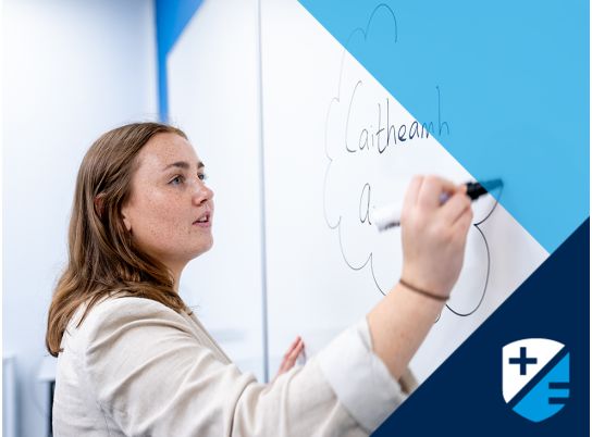 Teacher Rachel Lammond writing on whiteboard