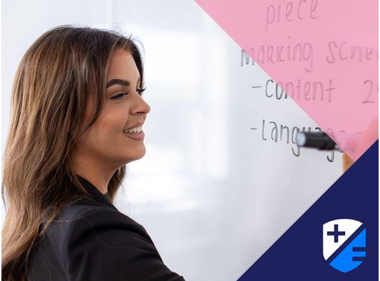 Teacher Katie Lenehan writing on whiteboard