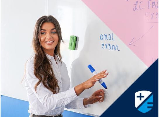 Teacher Katie Lenahan speaking in front of a whiteboard