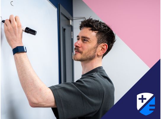 Teacher Kevin writing on a whiteboard