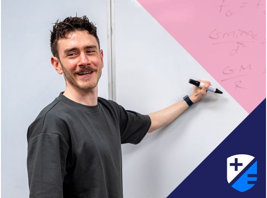 Teacher Kevin Fitzpatrick writing on whiteboard