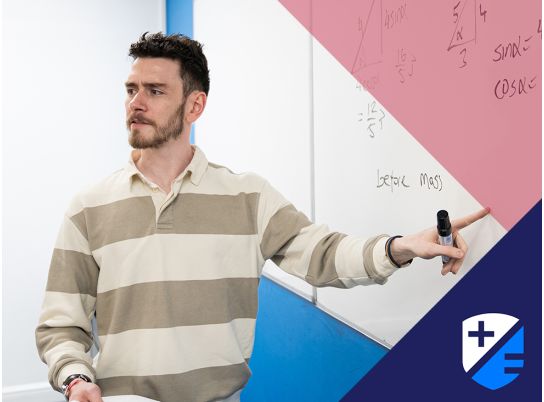 Teacher Kevin Fitzpatrick speaking in front of a whiteboard