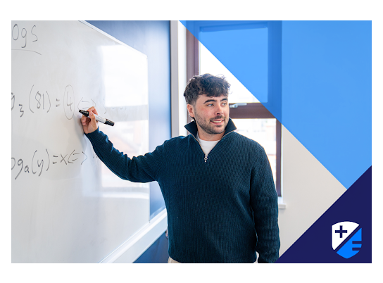 Teacher David Langley writing on whiteboard