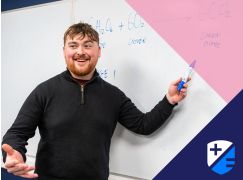 Teacher Alex Burke in front of a whiteboard 