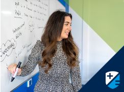 Teacher Annmarie Sheahan writing on a whiteboard