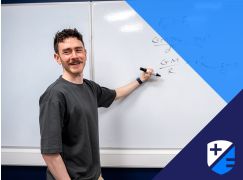 Teacher Kevin Fitzpatrick speaking in front of a whiteboard