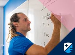 Teacher Barry Drumm writing on a whiteboard