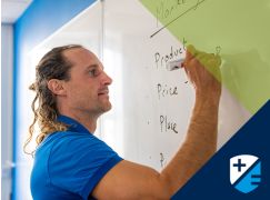 Teacher Barry Drumm writing on a whiteboard