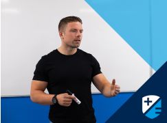 Teacher Dave Lewis speaking in front of a whiteboard