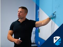 Teacher Dave Lewis speaking in front of a whiteboard