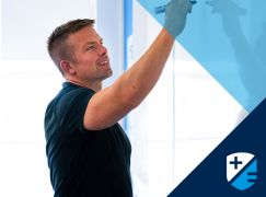 Teacher Dave Lewis writing on a whiteboard