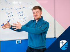 Teacher David Langley speaking in front of a whiteboard