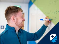 Teacher David Langley writing on a whiteboard