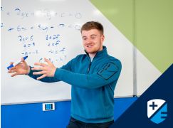 Teacher David Langley speaking in front of a  whiteboard