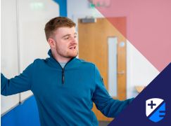 Teacher David Langley speaking in front of a whiteboard