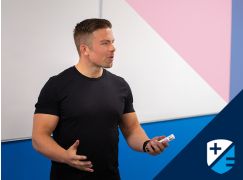 Teacher David Lewis speaking in front of a whiteboard