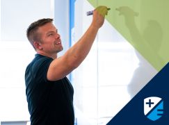 Teacher Dave Lewis writing on a whiteboard