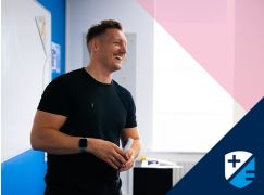Teacher Gavin Cowzer speaking in front of a whiteboard