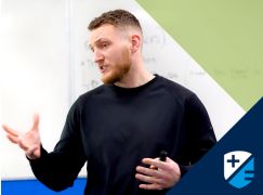 Teacher Gavin Cowzer speaking in front of a whiteboard