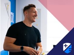 Teacher Gavin Cowzer speaking in front of a whiteboard