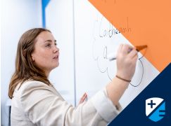 Teacher Rachel Lammond writing on a whiteboard