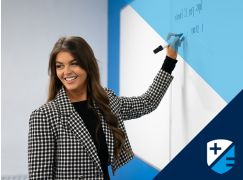 Teacher Katie Lenahan writing on a whiteboard