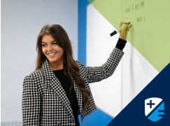 Teacher Katie Lenahan speaking in front of a whiteboard