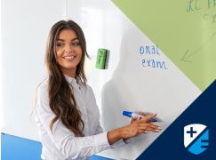 Teacher Megan Katie Lenahan speaking in front of a whiteboard