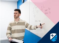Teacher Kevin Fitzpatrick speaking in front of a whiteboard