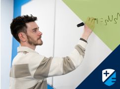 Teacher Kevin Fitzpatrick writing on a whiteboard