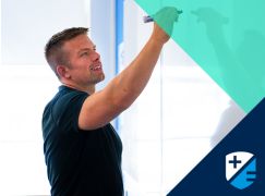 Teacher Dave Lewis writing on a whiteboard