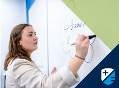 Teacher Rachel Lammond writing on a whiteboard