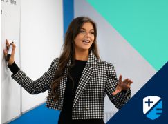 Teacher Katie Lenahan speaking in front of a whiteboard