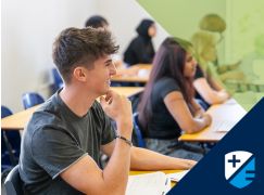 Male student smiling in class