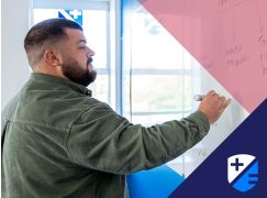Teacher Thomas Maher writing on a whiteboard